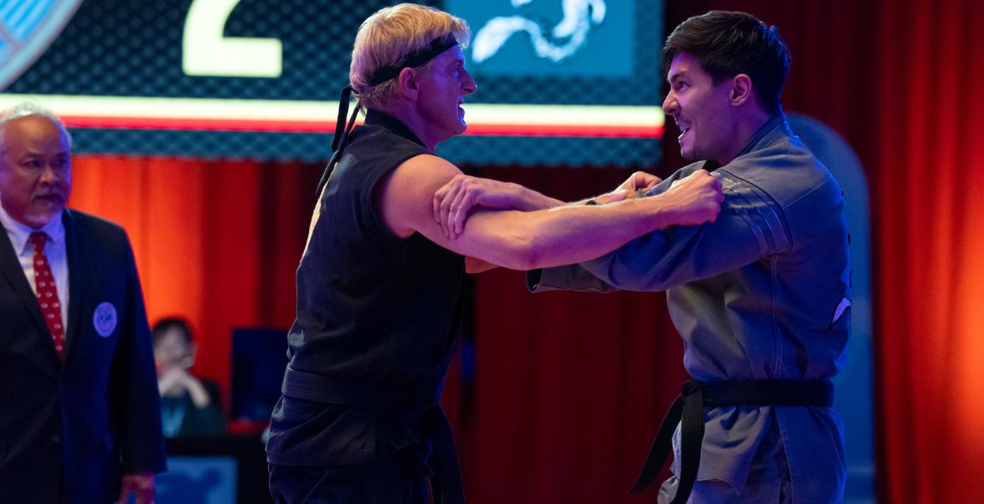 WIlliam Zabka as Johnny Lawrence and Lewis Tan as Sensei Wolf In Cobra Kai Season 6 part 3 from Netflix