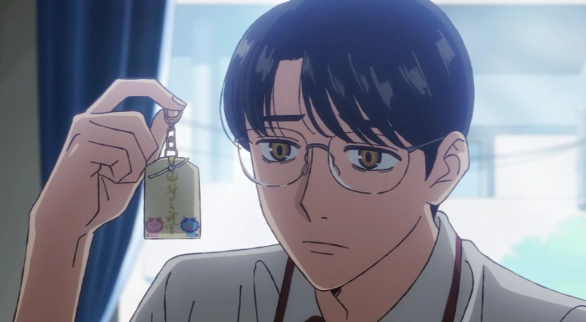 Satomi looks at his good luck charm