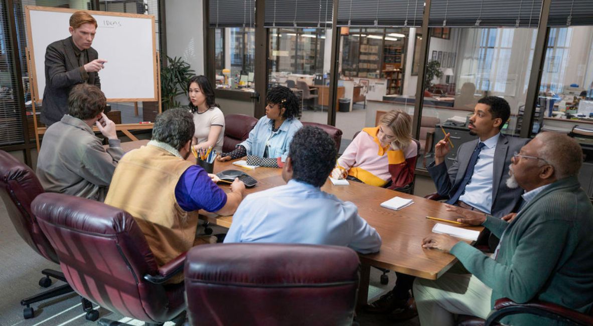 The staff of The Truth Teller meet in a conference room in Season 1 of The Paper