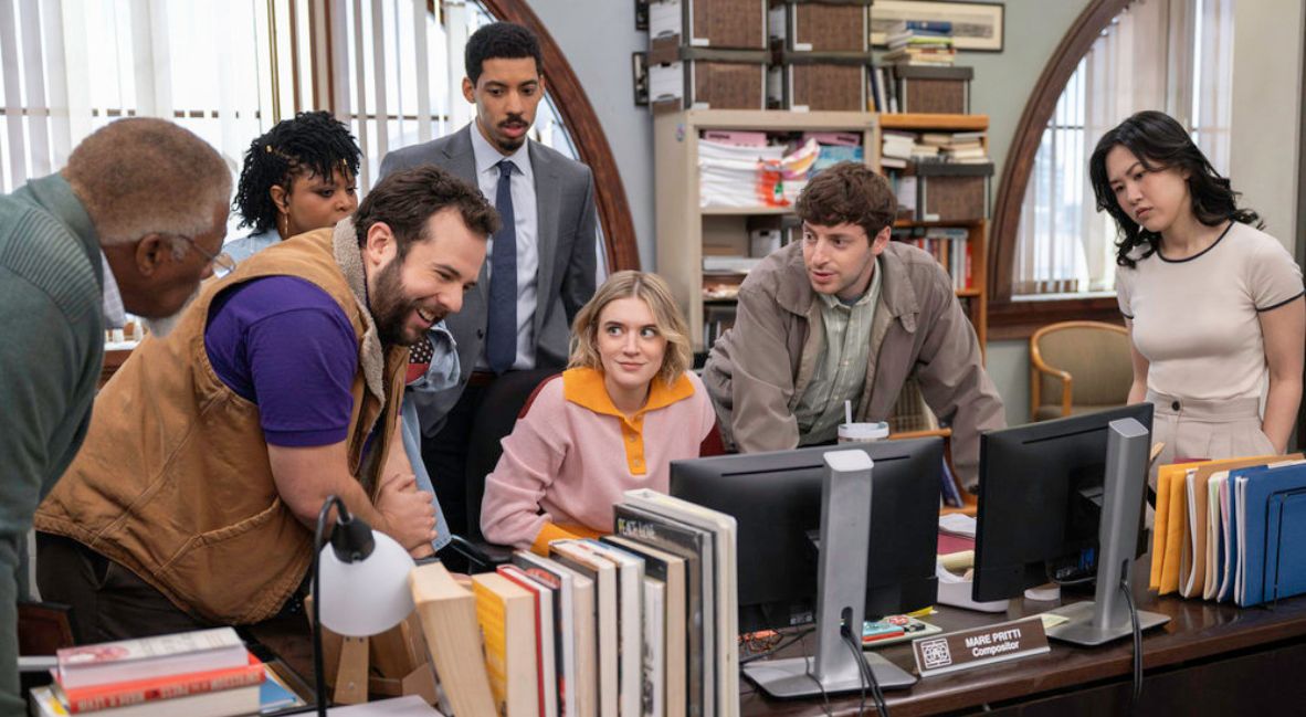 The Truth Teller Staff gathers in an office in Season 1 of The Paper
