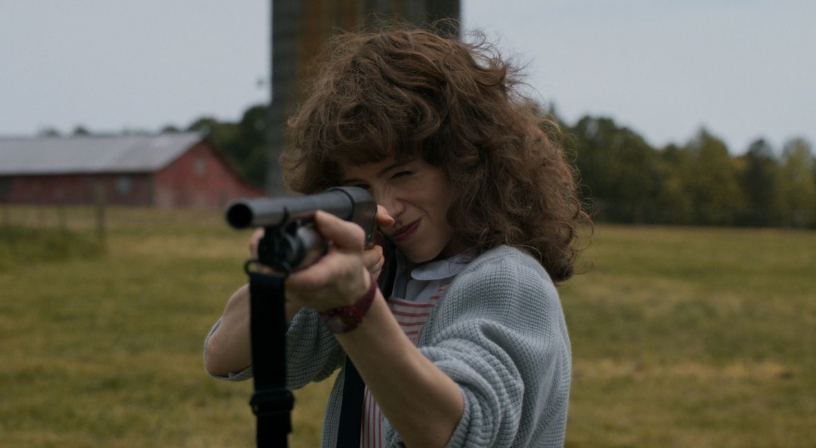 Nancy holding a shotgun 