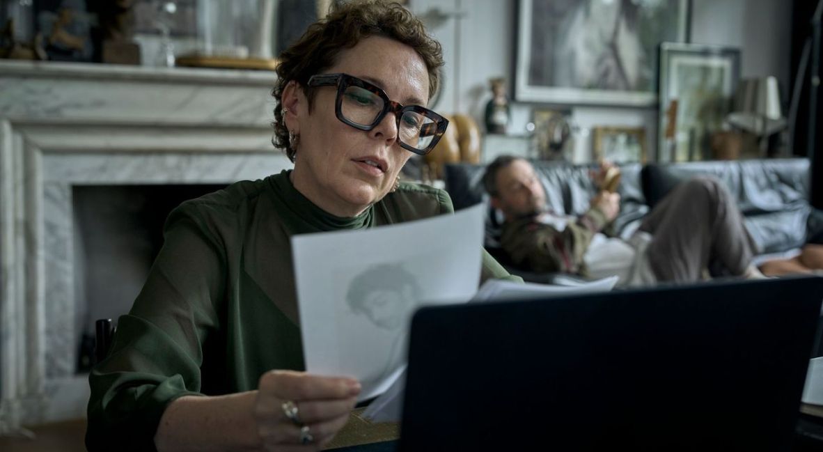 Hannah looks at an image while writing