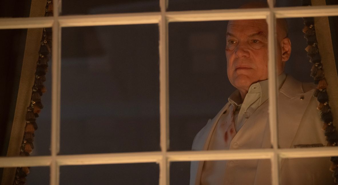 Wilson Fisk stands behind his window