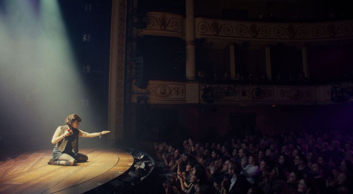 A wide shot of Eva Noblezada on stage in Hadestown The Musical