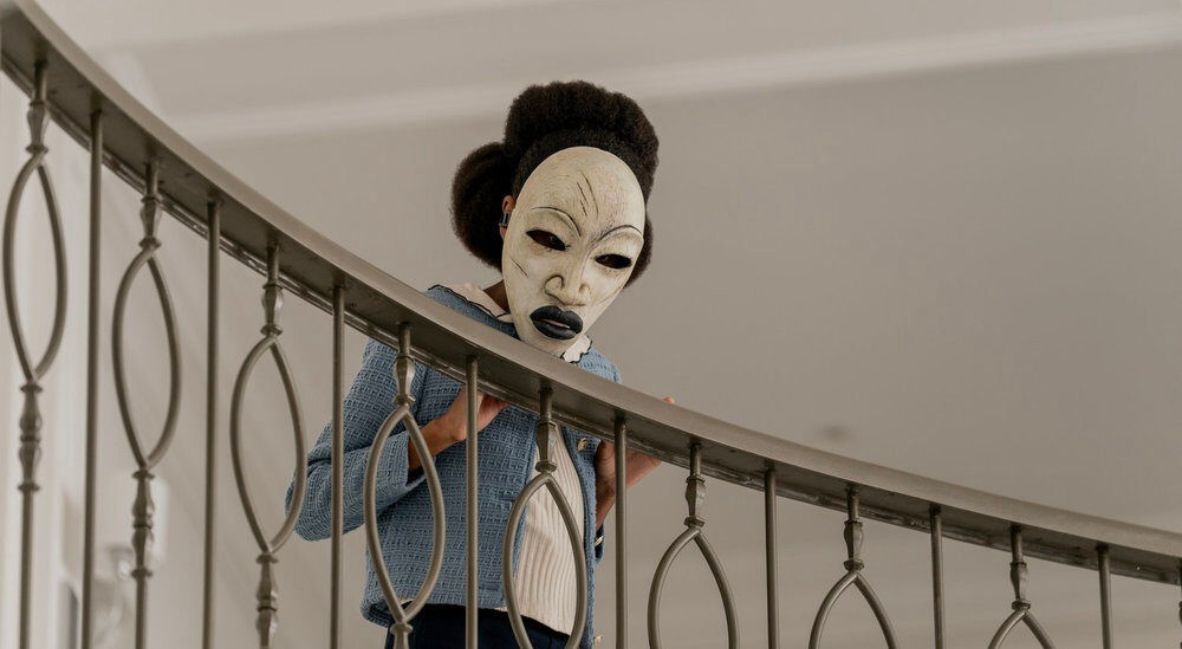 Zuri looks over a banister 