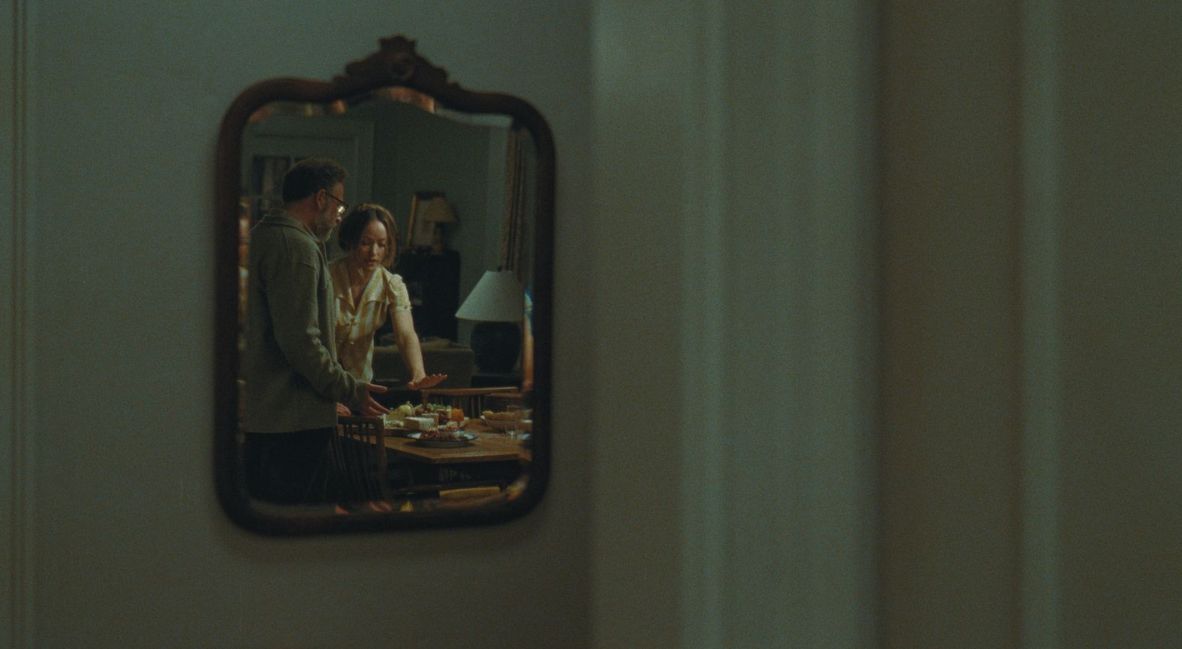 Seth Rogen and Olivia Wilde as Joe and Angela reflected in the mirror