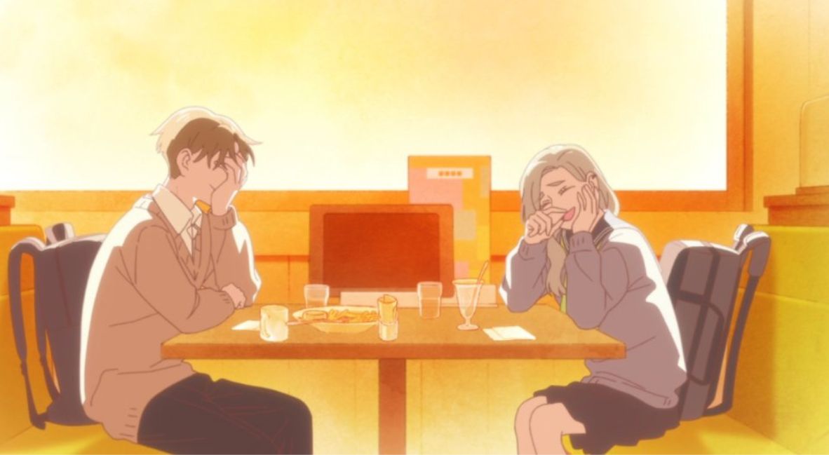 Taira and Azuma laugh together while sitting at a diner