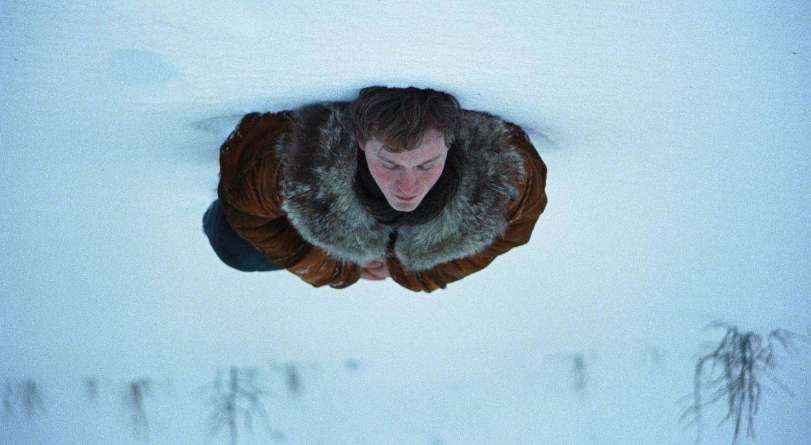 An upside down shot of Mike laying in the snow