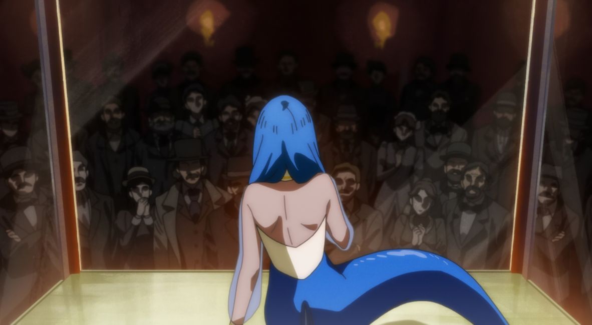 Lisa sits caged in front of an audience