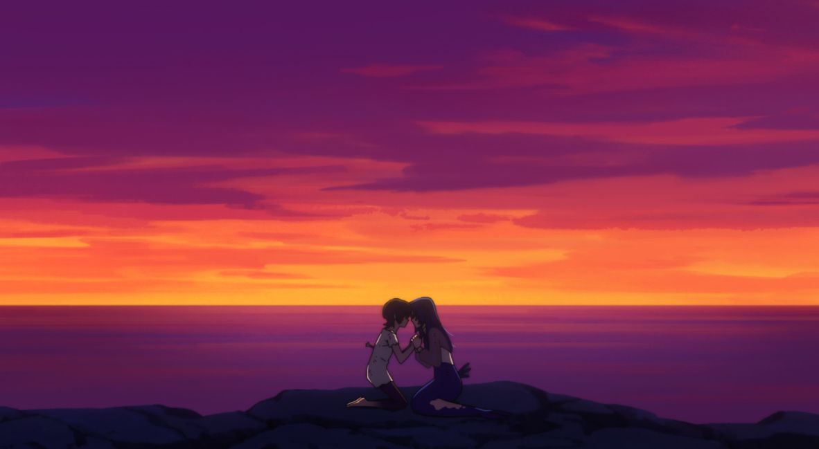 Kota and Lisa grab hands against a sunset