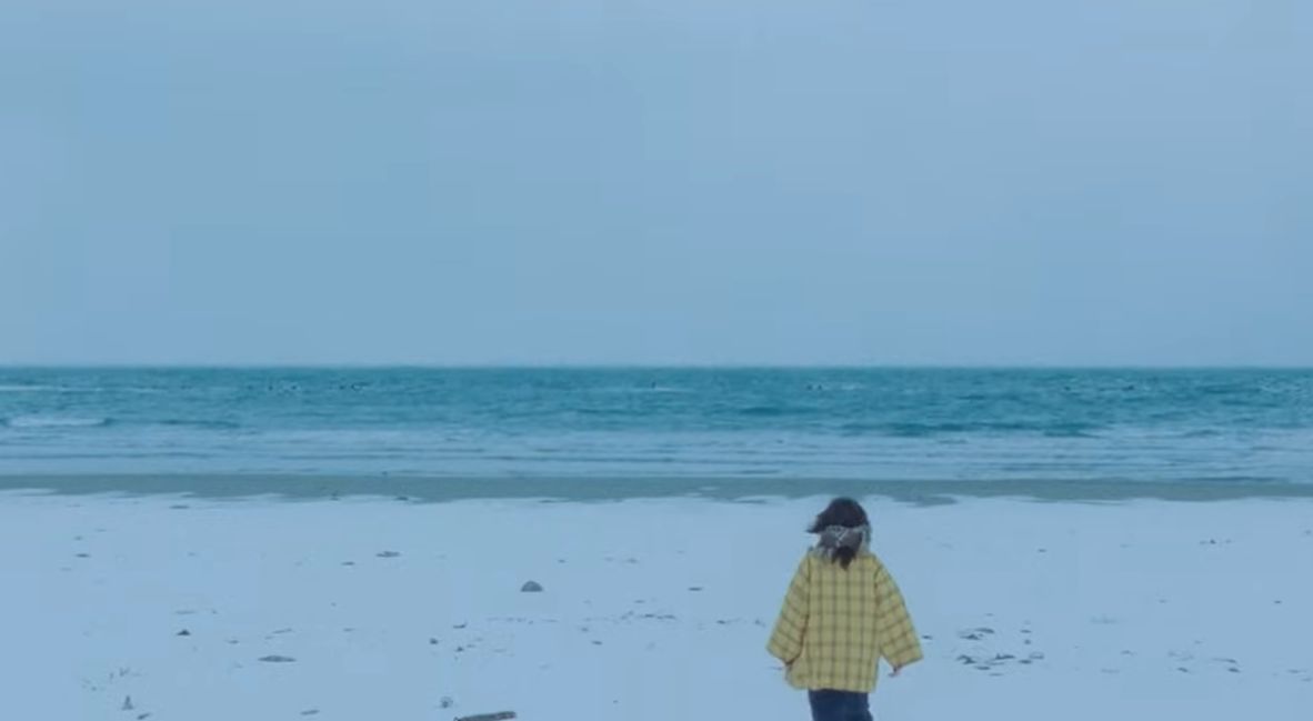 Kyomoto faces the edge of the ocean
