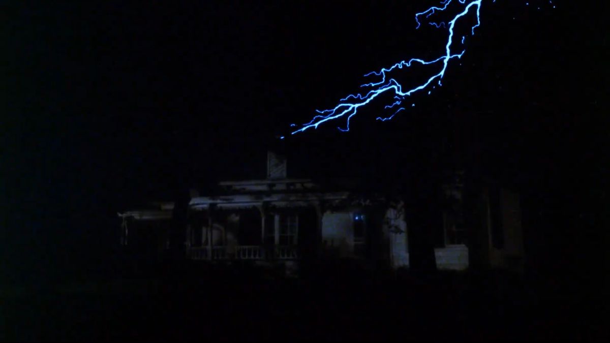 Lightning strikes over a house