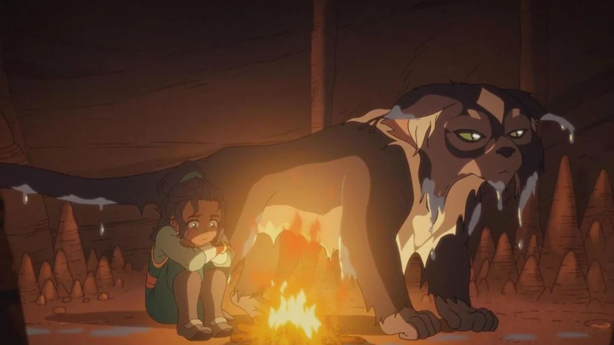 Nishi and Ruhi sit around a fire