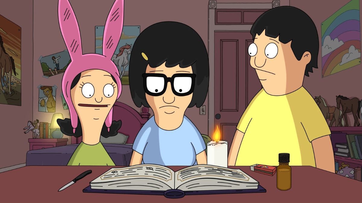 Louise, Tina, and Gene read a book next to a candle