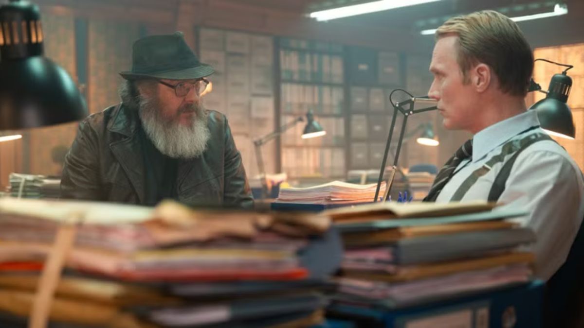 Ultron and Vision sit and talk next to piles of documents